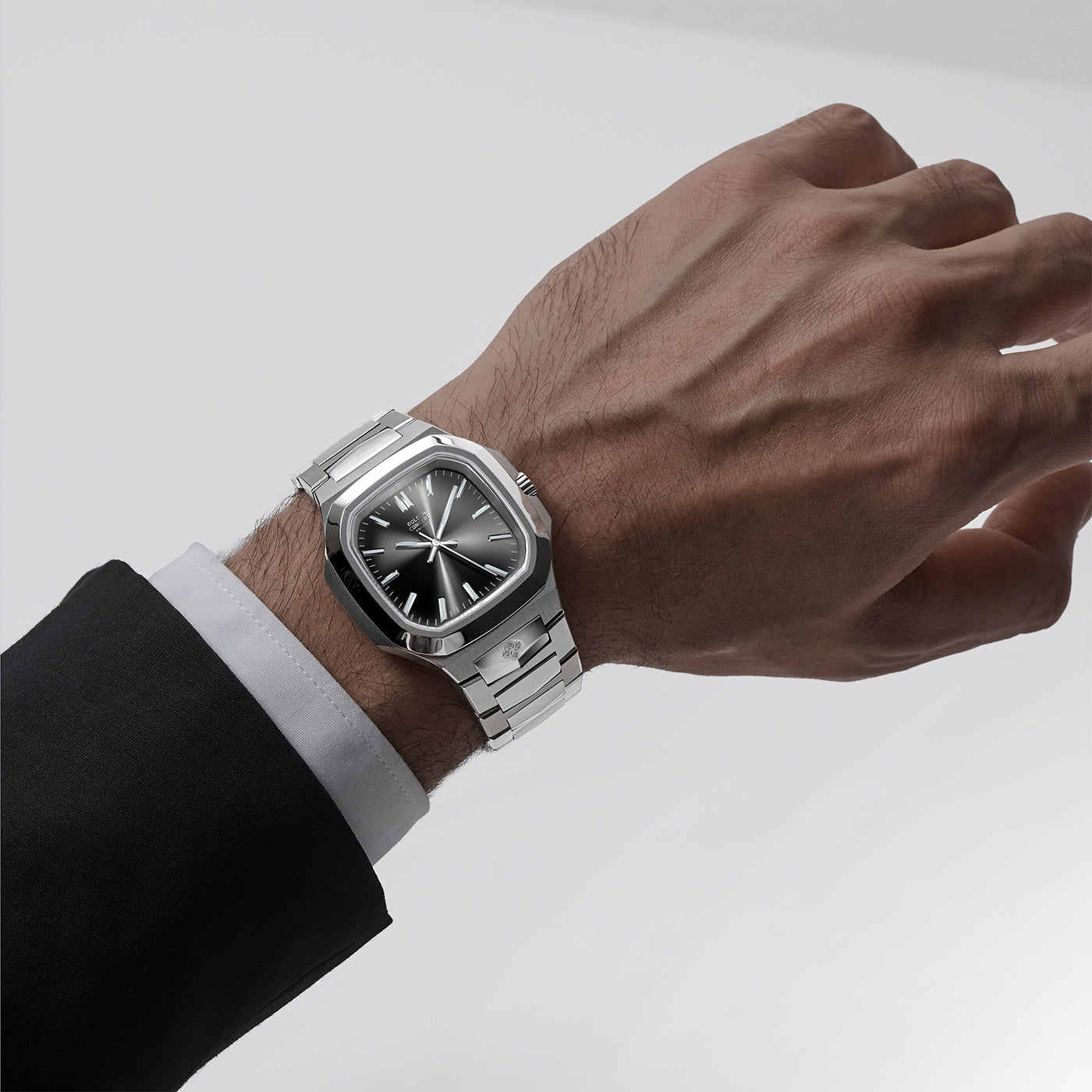 Golden Concept automatic watch on wrist showing stainless steel bracelet and black sunburst dial