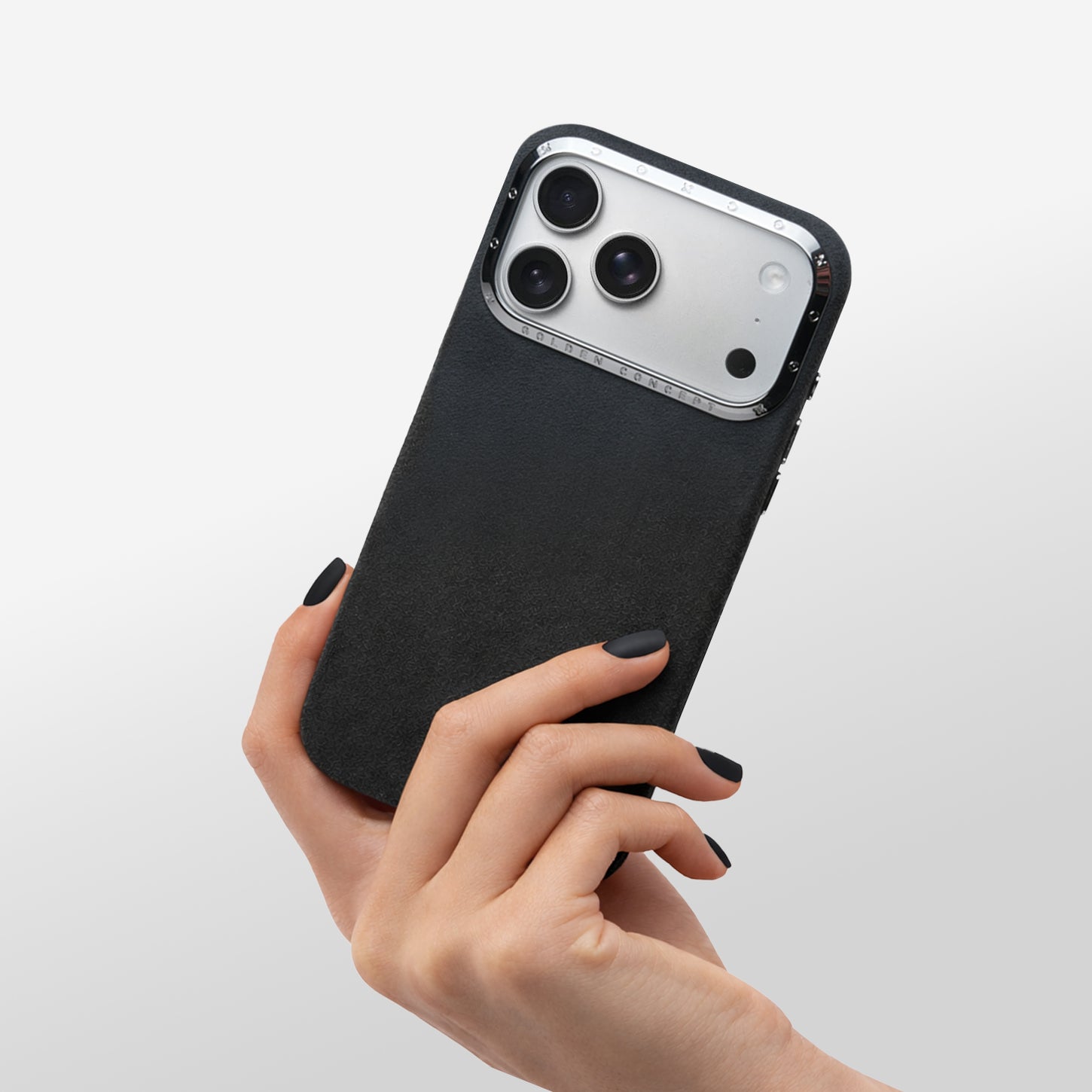Hand holding Black Alcantara iPhone 17 case with high-polished aluminum camera frame